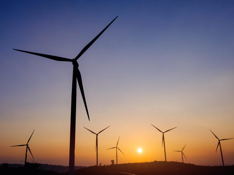 Silhouette wind turbine field generate of electrical with sunset sky background