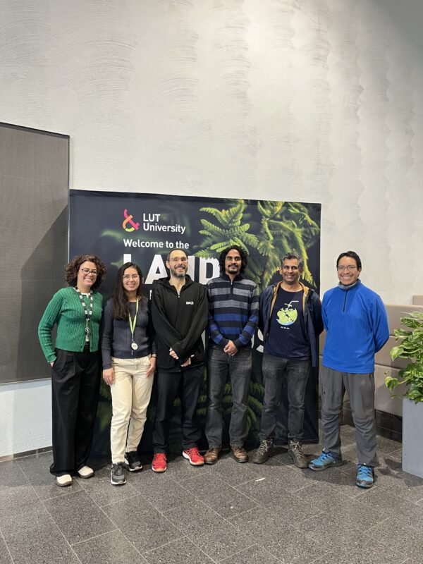 With_LUT_people Group of people in front of an LUT University banner smiling.