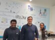 Photo of 3 people including Hossein at the IRIDA Centre in Cyprus.