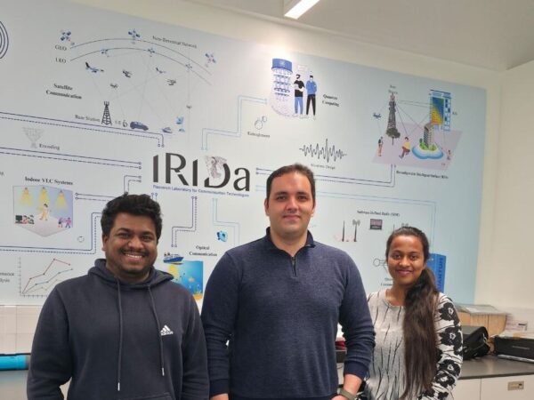 Photo of 3 people including Hossein at the IRIDA Centre in Cyprus.