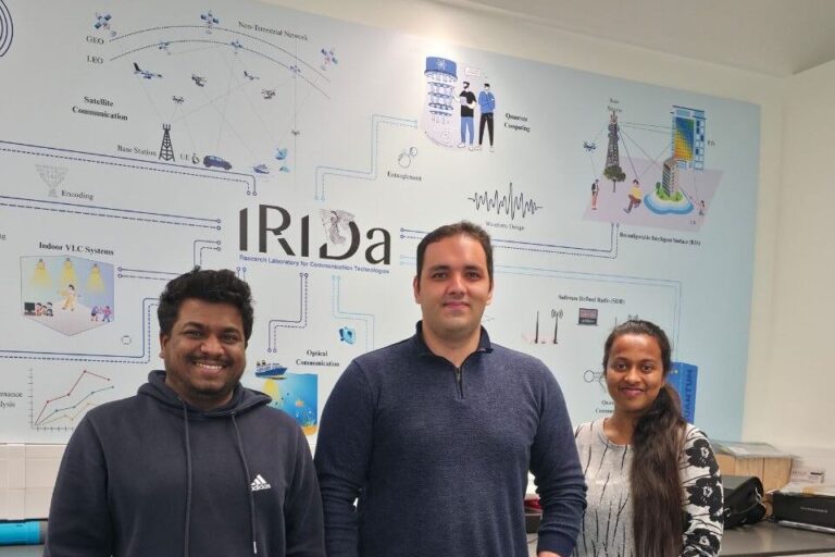 Photo of 3 people including Hossein at the IRIDA Centre in Cyprus.