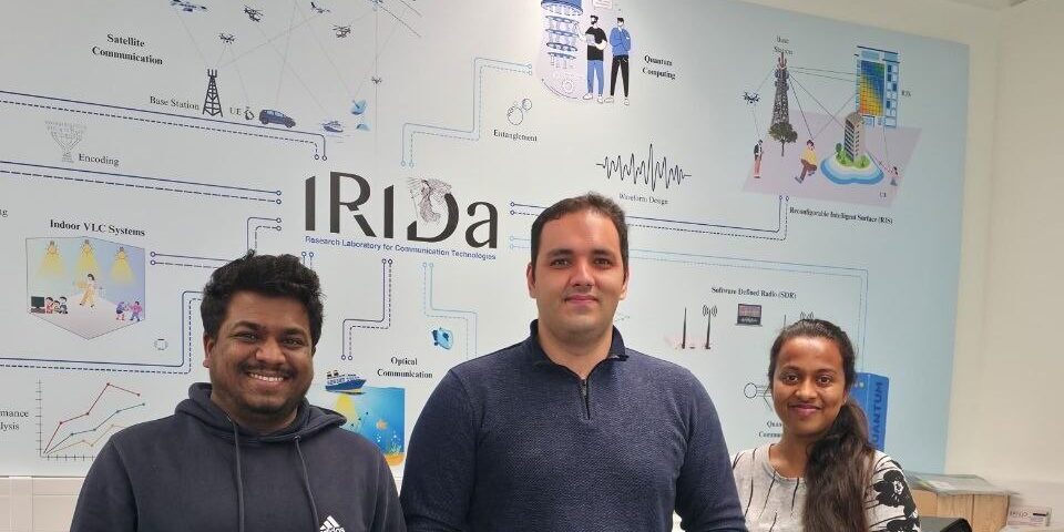 Photo of 3 people including Hossein at the IRIDA Centre in Cyprus.