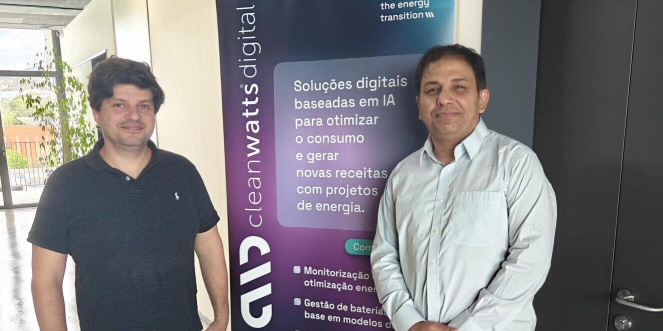 Mehar Dr. Mehar Ullah posing for photo with colleague in front of Cleanwatts Digital pull up banner