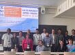Coalesce partners posing for photo in front of presentation at the IEEE RTSI Conference 2026 in Finland